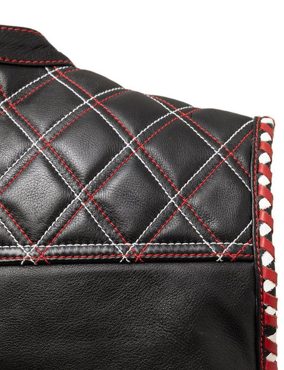 Close-up of a black leather product with red stitching and white accents on a white background