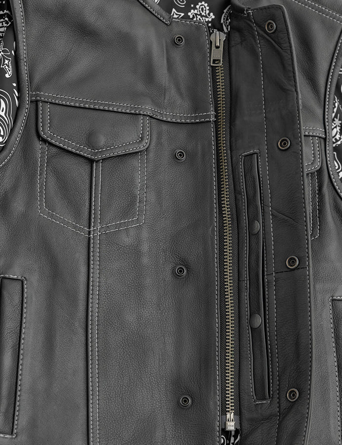 Close-up of a gray leather jacket with patches and zippers