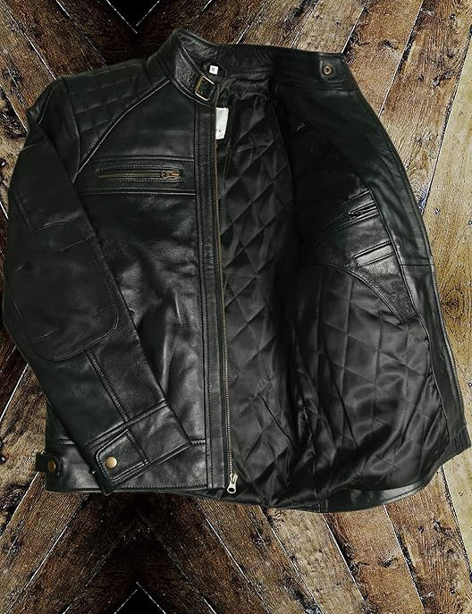 Black leather jacket with quilted design on a wooden surface