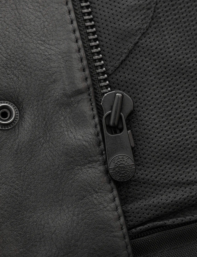 Close-up of a zipper on a textured surface