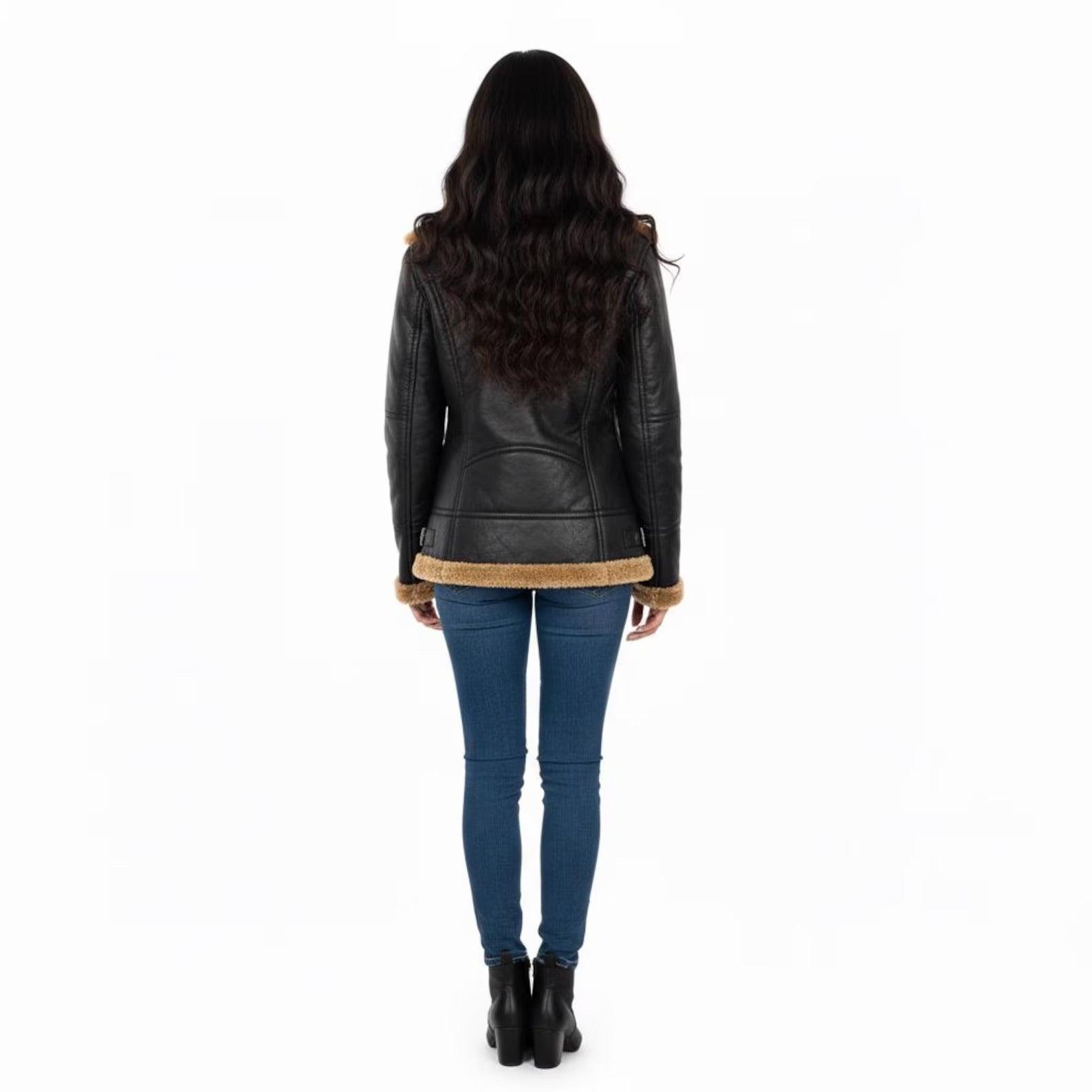 Person wearing a black leather jacket with fur trim on a white background
